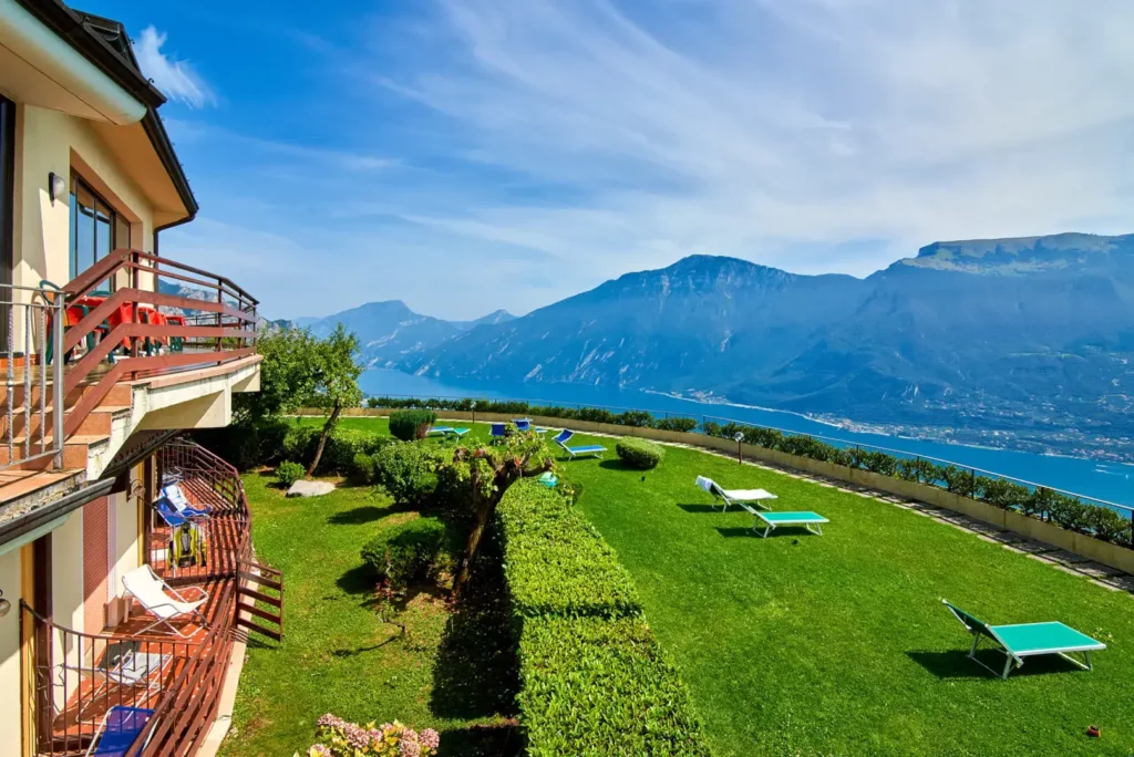 Villa with garden and mountain lake view.
